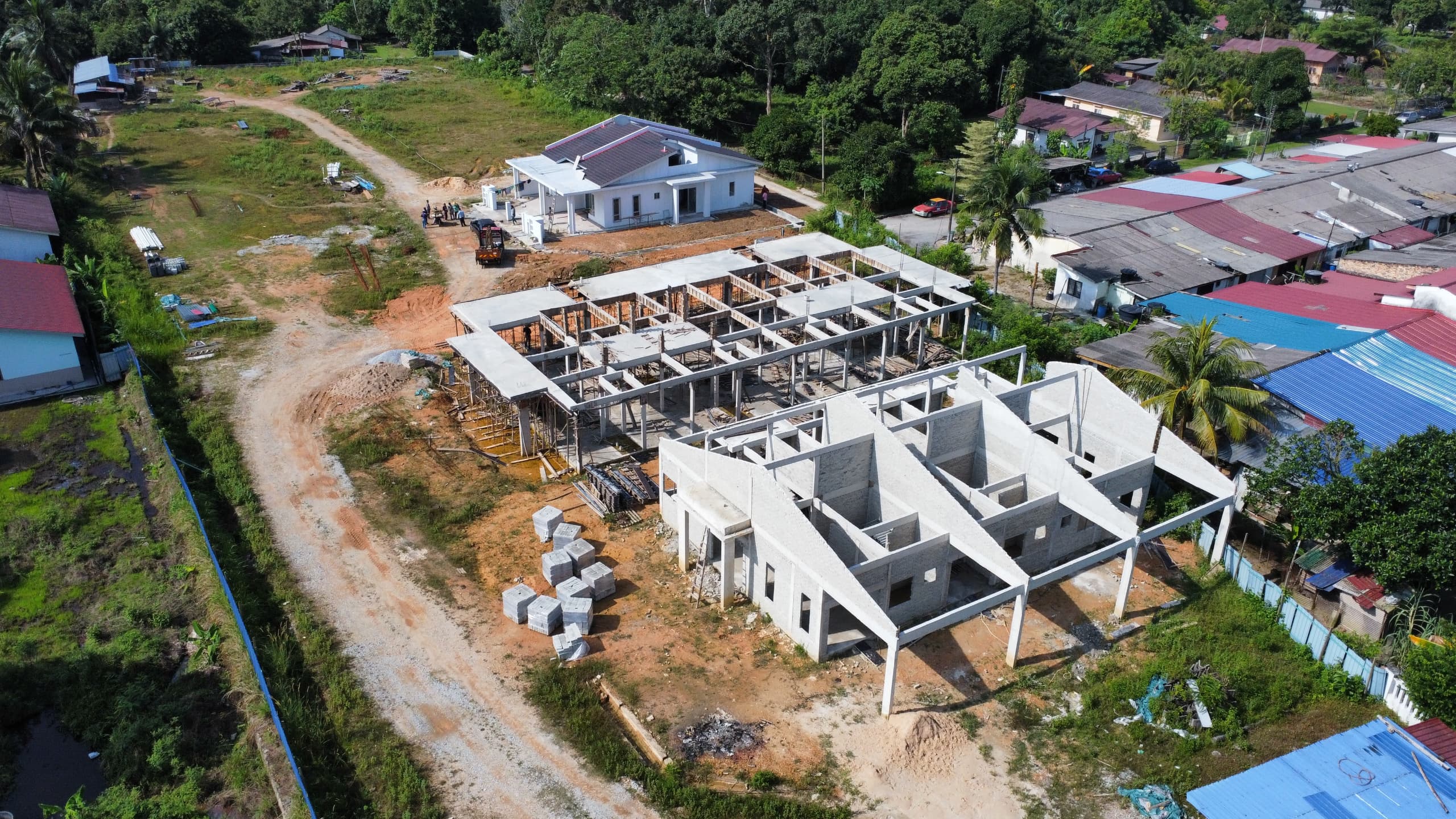 Development overview showing multiple houses in different construction stages