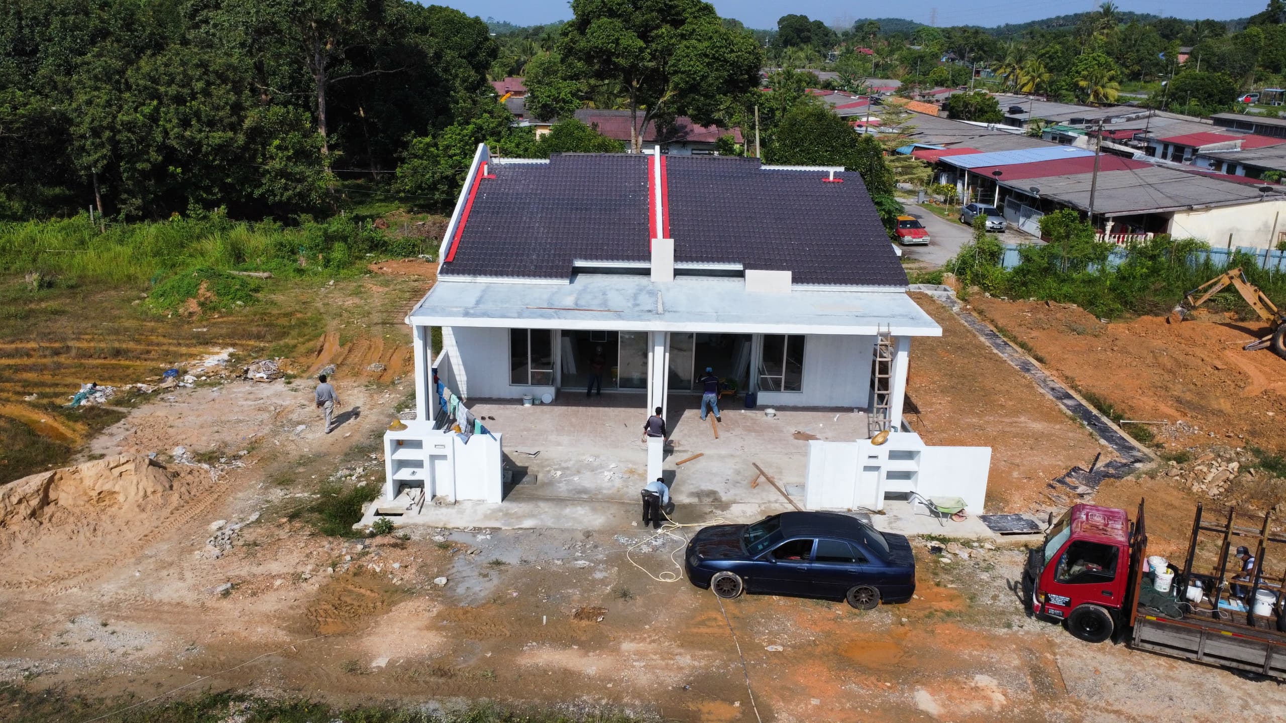 Front view of house under construction with workers