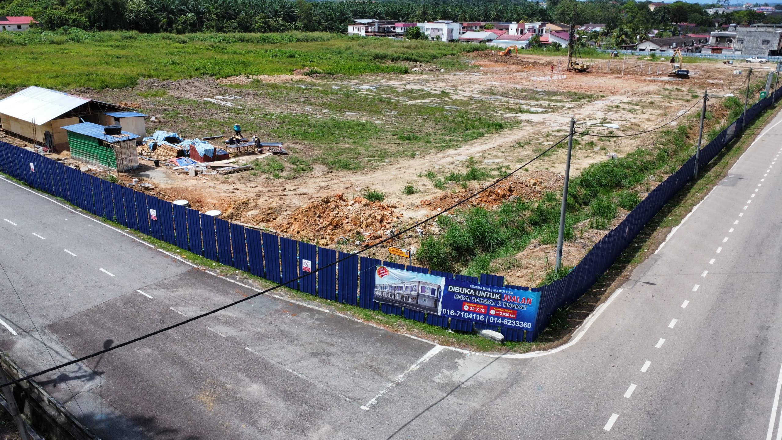 Construction site with blue fencing and project sign